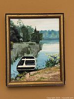 Full view of framed landscape oil painting on wall