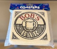 Front of sealed coaster pack showing Bob’s Bar graphic and header card