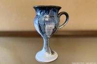 front view of blue glazed goblet mug on pedestal base