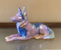 Front left perspective showing entire glazed ceramic dog figurine