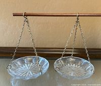 Both hanging crystal dishes suspended from wooden rod