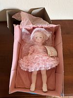 Doll inside original box with pink interior