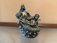 Front view of metal mermaid figurine
