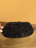 Overall front view of black beaded Josef clutch