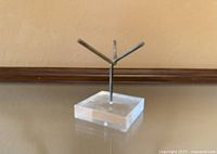 Front angle of lucite base and metal arms