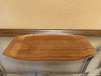 Top view of rectangular teak tray showing grain and shape