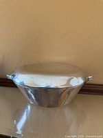 Side view showing bowl contours and lid seated