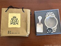 Harrods tea scoop and strainer in box beside Borghese gift bag