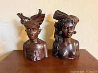 Front view of both teak bust bookends