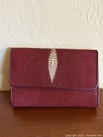 Front view showing red stingray skin and central spine accent