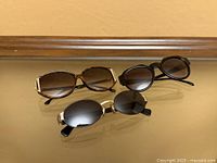 Front view of three pairs of sunglasses