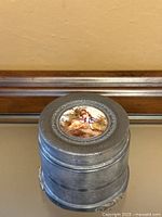 Top view showing enamel medallion and metal lid detailing