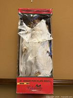 Front view of boxed porcelain angel doll