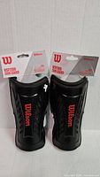 Two packaged Wilson WSP2000 adult shin guard sets front view