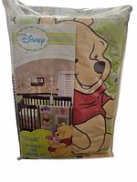 Front view of sealed Disney Winnie the Pooh crib bedding set package showing Pooh graphic and crib scene