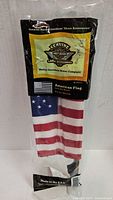 Front view of sealed package showing Harley-Davidson branding and flag inside