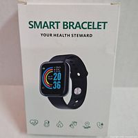 Front of unopened box showing Smart Bracelet Your Health Steward smartwatch with black band