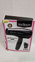 Front of retail box showing Hot Beauty Professional 1875 W ceramic blow dryer and bonus comb attachment