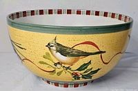Side view showing bird, holly, green rim and plaid border