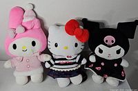 Group shot of all three Sanrio plush toys