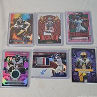 Six sleeved cards laid out