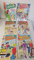 Front view of six bagged Betty & Veronica comics laid out
