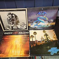 Four LPs including Asia, Queen Live Killers, Eagles Hotel California and unidentified black-and-white cover