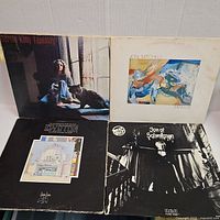 Front covers of four vintage vinyl LPs: Carole King Tapestry, Joni Mitchell Mingus, Led Zeppelin The Song Remains The Same, Nilsson Son of Schmilsson