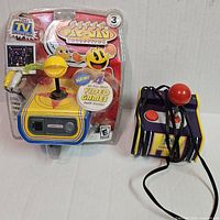 Sealed Super Pac-Man Collection plug-and-play unit beside loose Pac-Man joystick console