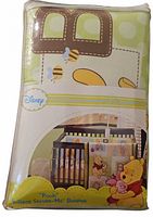 Front view of sealed Disney Pooh crib bumper package showing design and product info