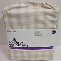 Front of sealed Room Essentials queen sheet set package showing gingham pattern and branding