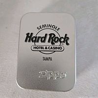 Front of silver tin showing Seminole Hard Rock Hotel & Casino Tampa logo and Zippo branding