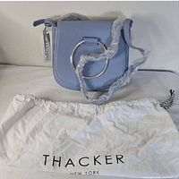 Full view of purse with dust bag, tags attached