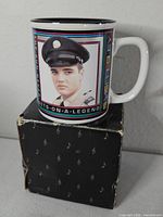 Mug atop original box showing Elvis image, border design and box pattern