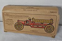 Cardboard box labeled The Vintage Collection Antique Reproductions Fire Ladder Truck by Enesco