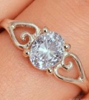 Ring worn on finger showing overall design and stone