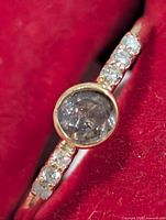 Ring angled view showing bezel-set alexandrite and shoulder diamonds