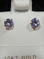Front view of tanzanite stud earrings on display card