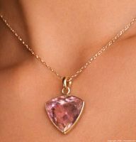 Pendant on model’s neck showing size and color