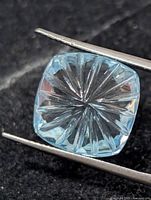 Front view of square cushion blue topaz showing starburst fantasy cut