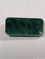 Top view of rectangular emerald showing color and cut
