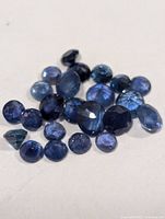 Group of faceted blue sapphires on white background