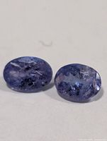 Pair of oval tanzanite gemstones front view