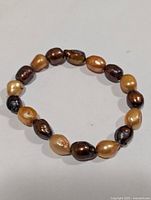 Bracelet overview showing multicolour baroque freshwater pearls on elastic cord