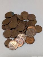 Loose stack of Canadian pennies on white background