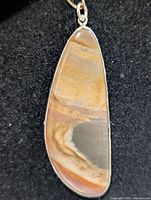 Front view of teardrop Crazy Lace Agate pendant