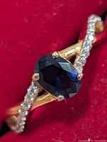 Front view showing oval created sapphire and cubic zirconia accents