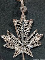Front view of silver maple leaf filigree pendant