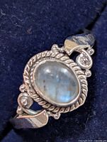 Front view showing labradorite cabochon, rope bezel and scroll design