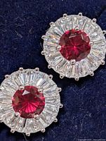 Front view of both earrings showing created ruby centres and CZ halo